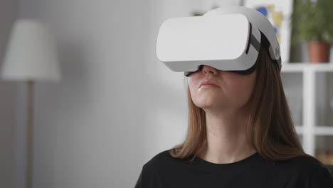 female-user-is-testing-new-model-of-head-mounted-display-for-virtual-reality-medium-portrait-of-woman-with-HMD-indoors-gadget-for-video-games-and-education